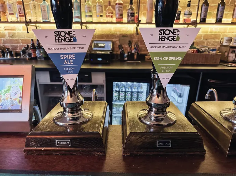 Hand pumps on the bar with Stonehenge Ales pump clips