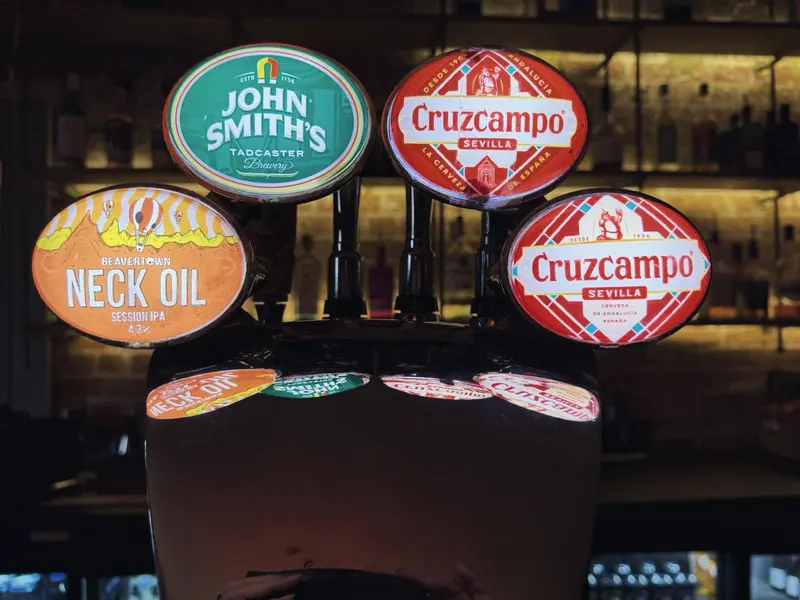 Lit pump clips on the bar for John Smith's, Neck Oil and Cruzcampo