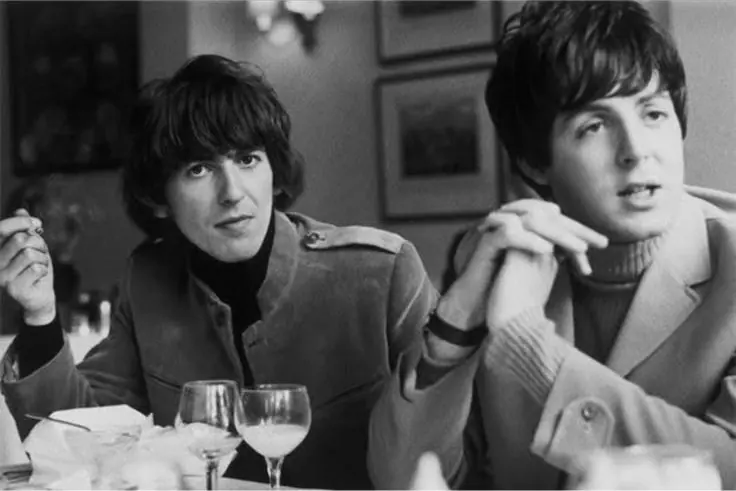 George Harrison and Paul McCartney at a lunch table at the hotel in 1965