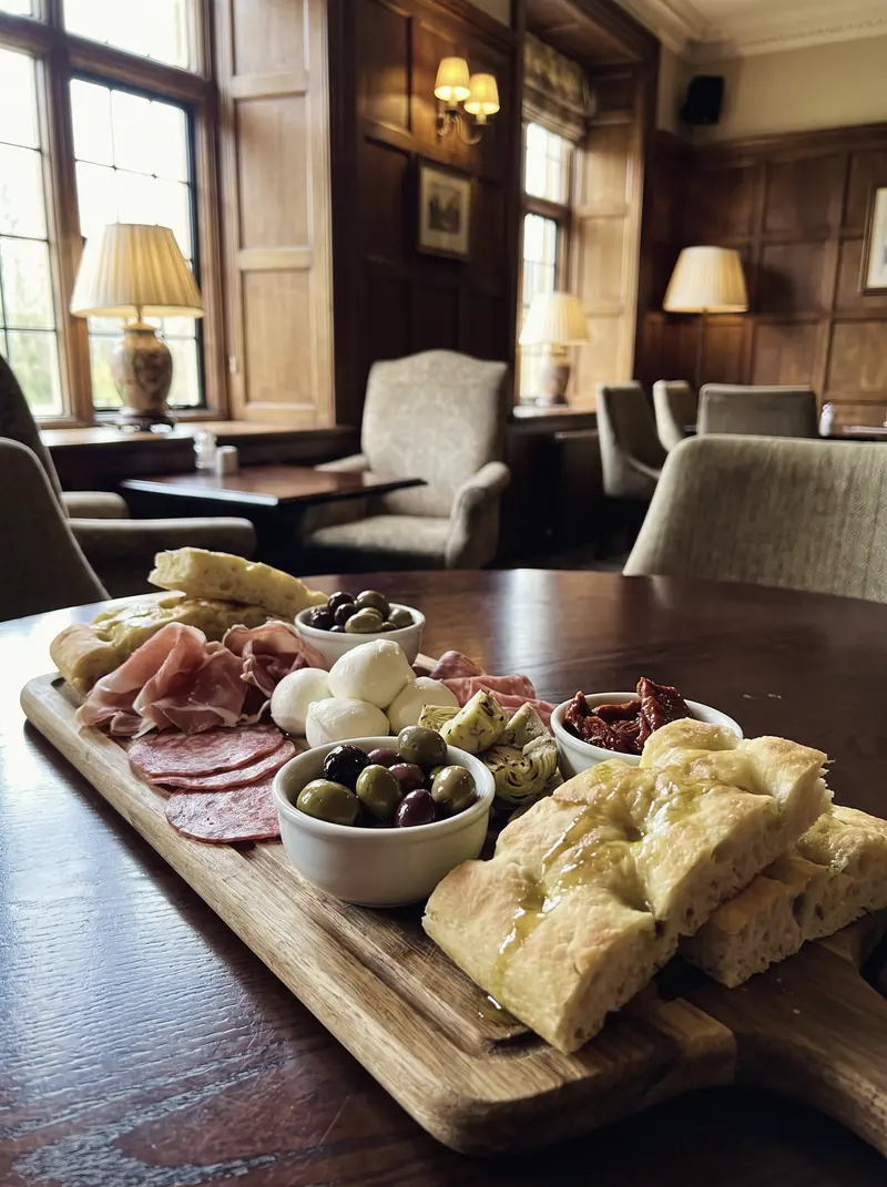 An antipasti board of cured meats, mozzarella, olives, artichokes and focaccia