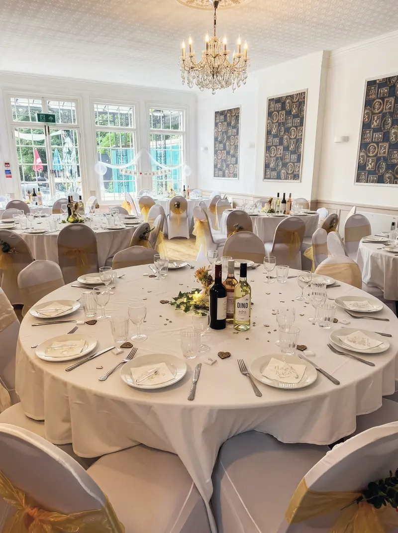 A round table laid for a formal dinner in the function room