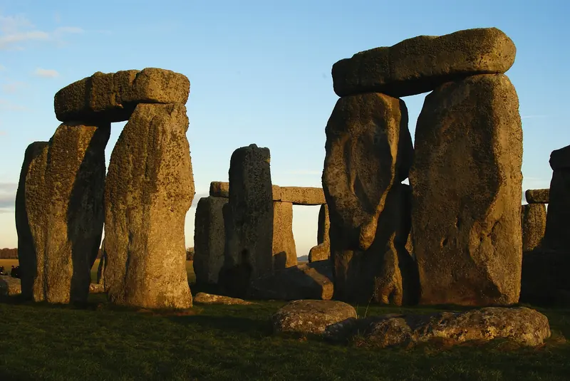 Close view of the sarsen trilithons at Stonehenge, lit by low sun