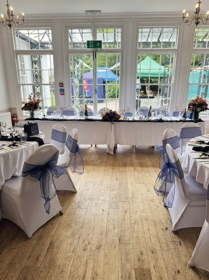 A long top table set in front of the garden windows