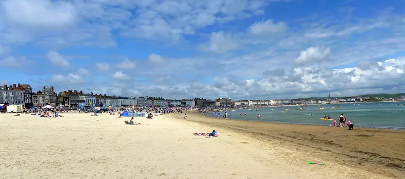 The sandy sweep of Weymouth beach with the seafront behind