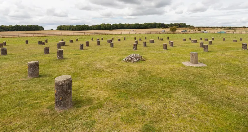 Woodhenge: short concrete posts marking the rings of timber posts, with a small flint cairn near the centre